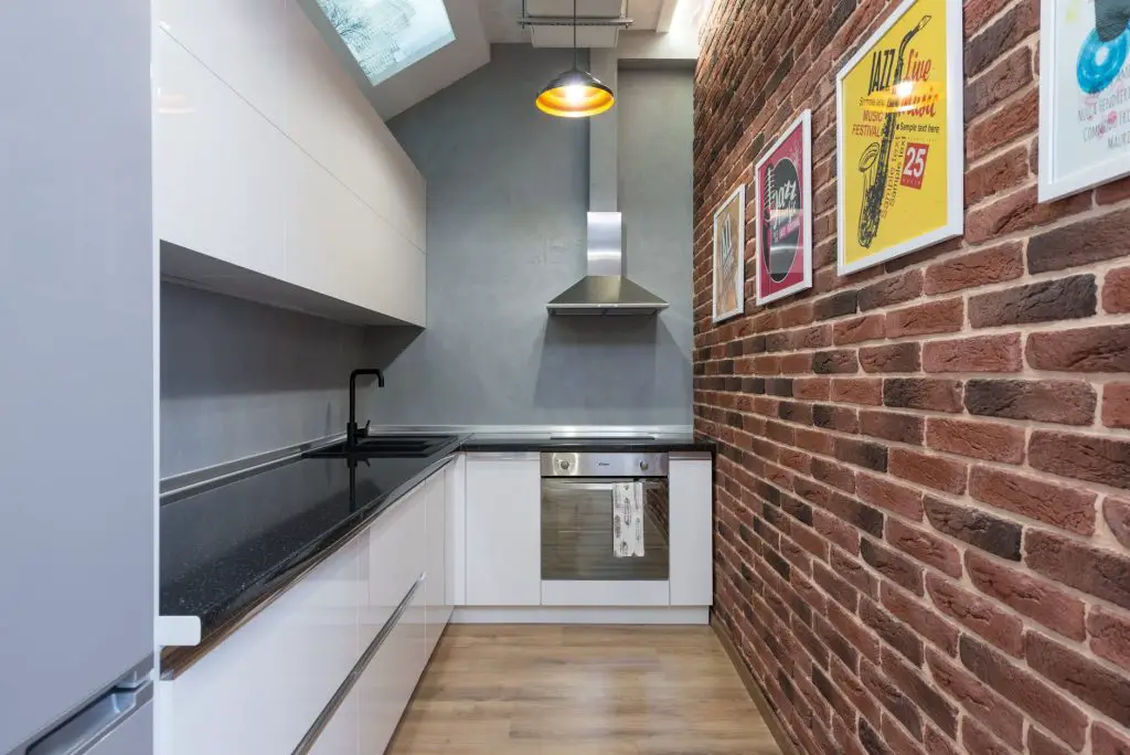 kitchen with decorated brick wall